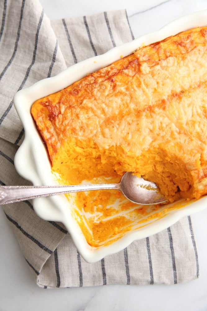 Overhead shot of the sweet potato souffle in a baking dish with a spoon.