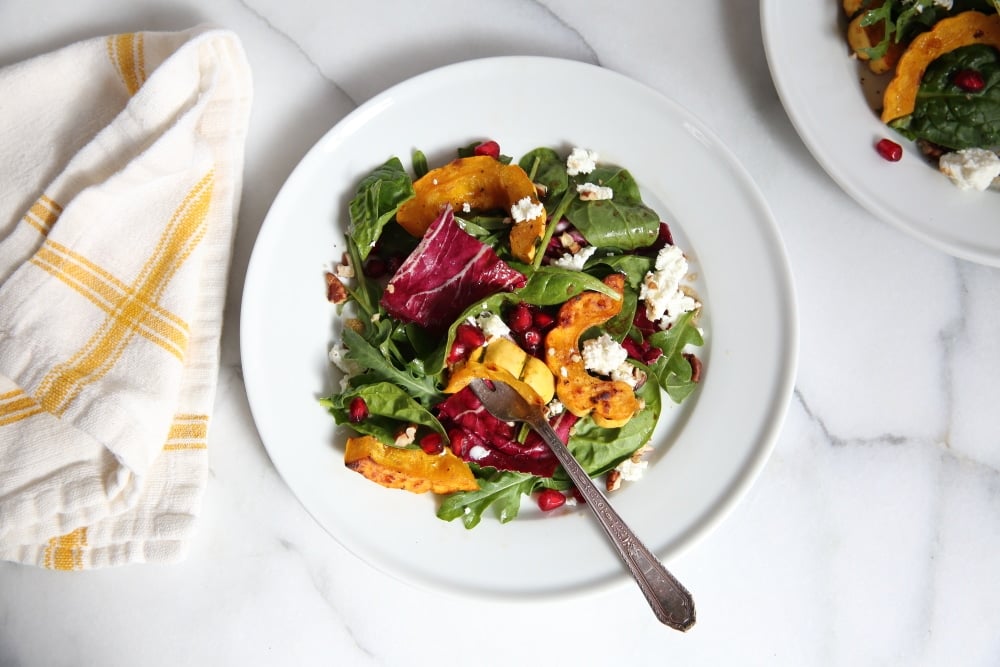 Overhead shot of the roasted squash salad on plate with a fork.