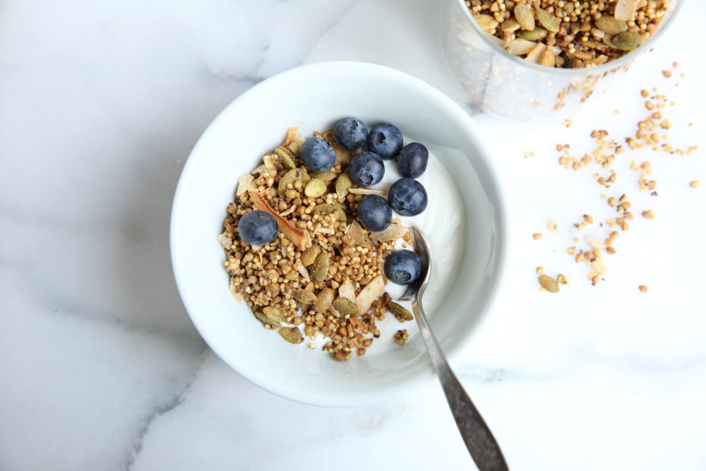 Millet granola in bowl with yogurt and blueberries