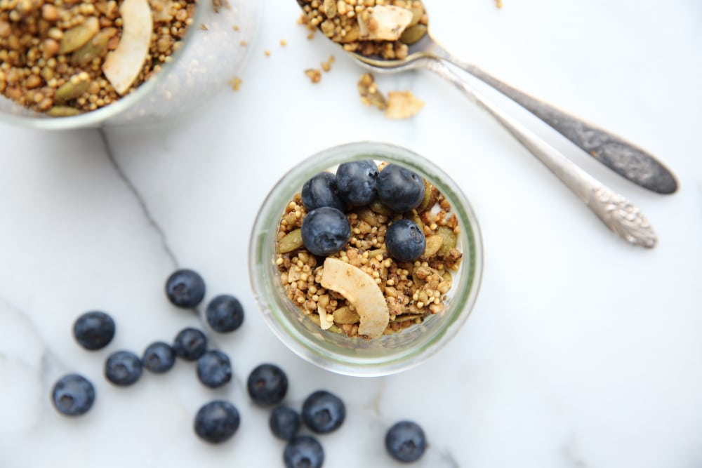 Overhead shot of millet granola in jar with blueberries