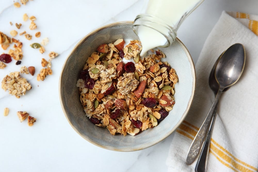 gluten free granola recipe in bowl with milk pouring over