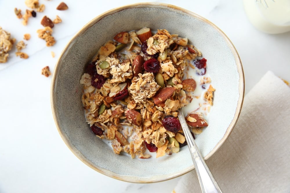 gluten free granola recipe in bowl with milk and spoon