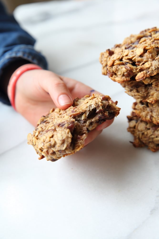 Close up of a hand holding a banana breakfast cookie.