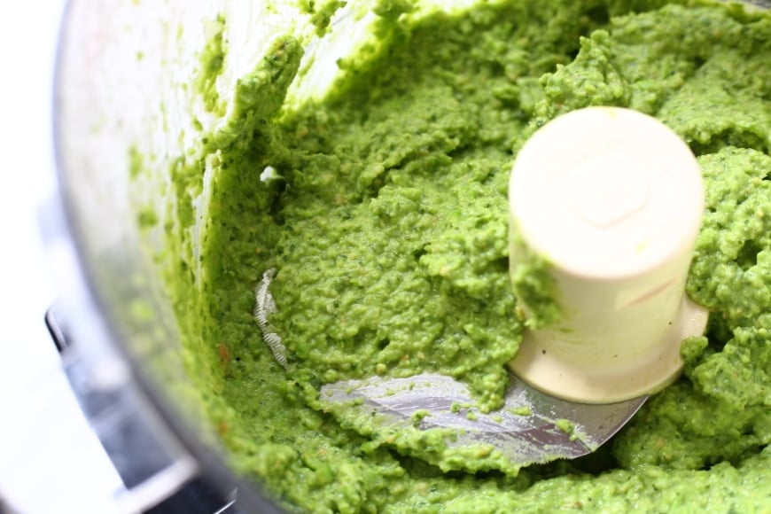 Close up of pea pesto in a food processor.