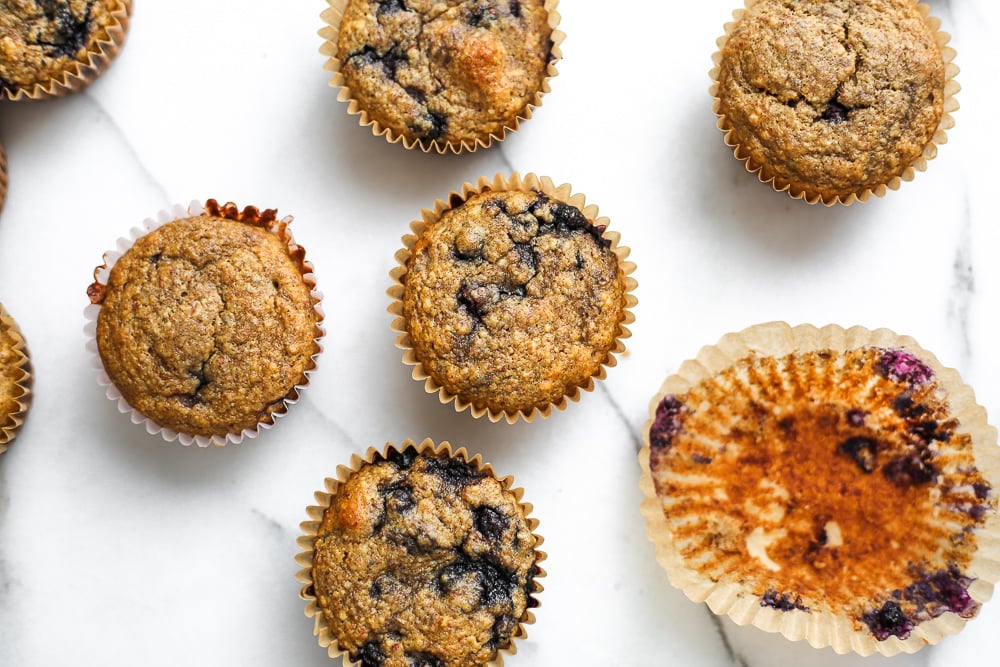 Overhead shot of blueberry blender muffins lined up on the counter.