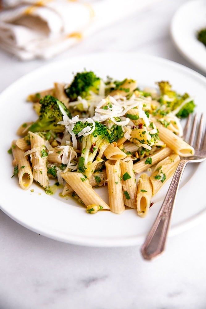 Broccoli pasta on plate with fork and napkin in background