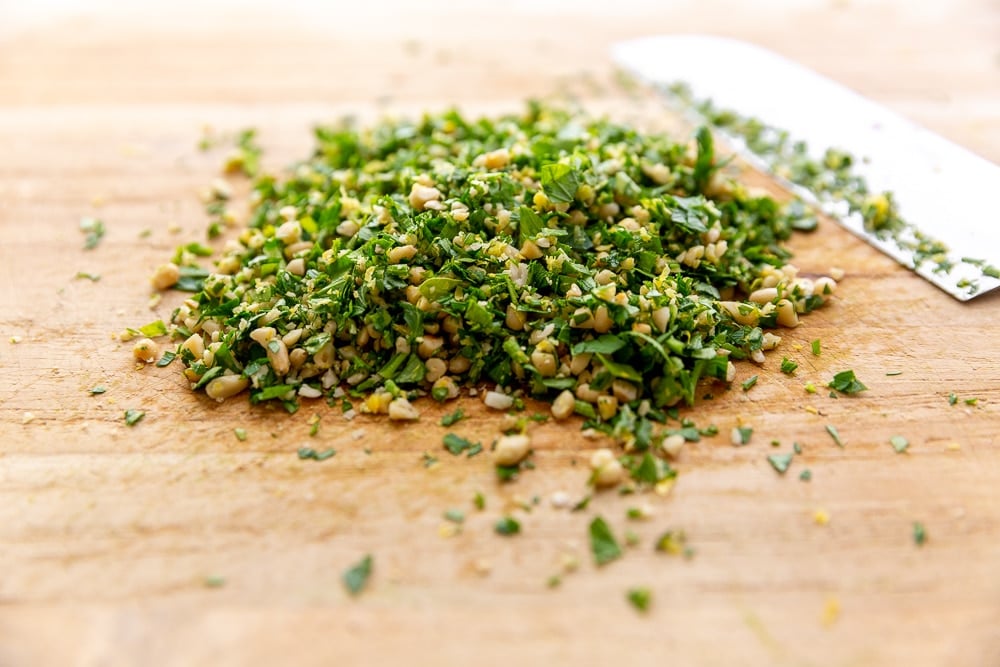 Gremolata chopped on cutting board with knife, for the broccoli pasta