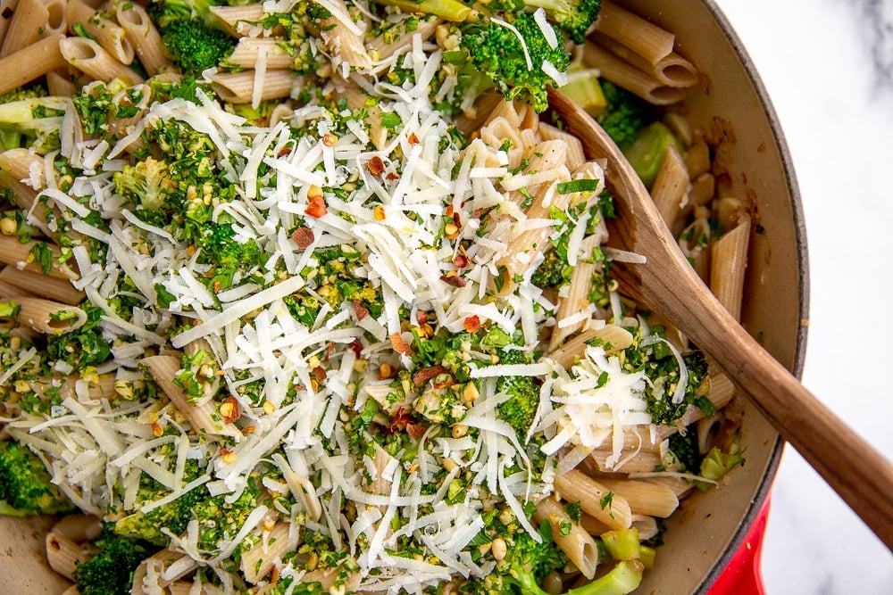 Broccoli pasta in skillet with wooden spoon