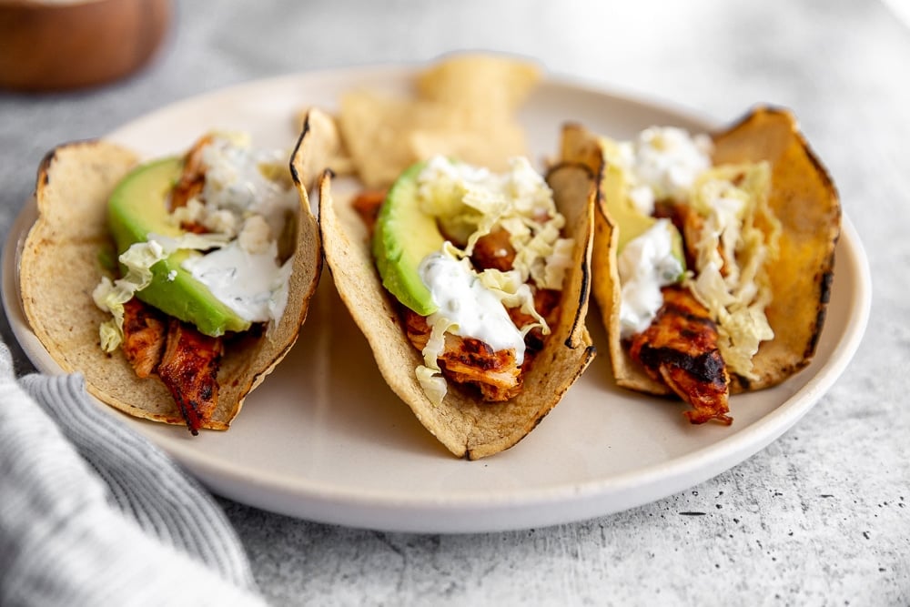 Easy chipotle chicken tacos lined up on a plate