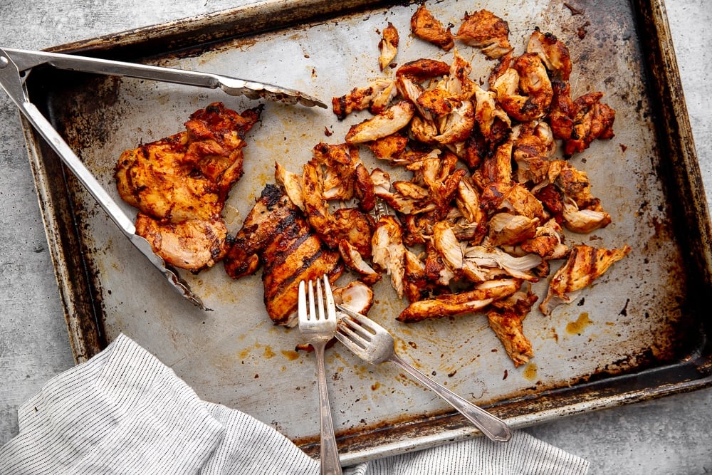 Grilled chipotle chicken thighs shredded on sheetpan