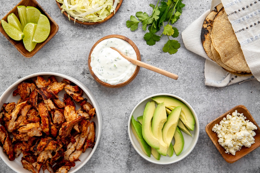 Ingredients to build easy chipotle chicken tacos on counter