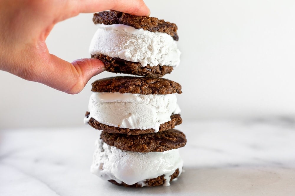 Hand grabbing ice cream sandwich from vegan ice cream sandwich recipe