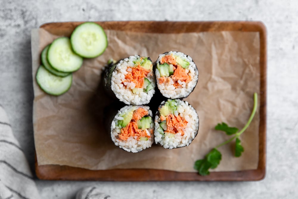 Spicy salmon sushi burritos on a serving platter.