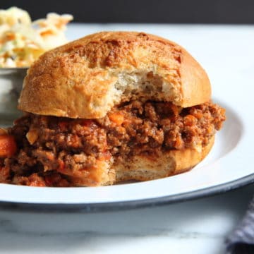 Healthy sloppy joes in bun on plate with coleslaw