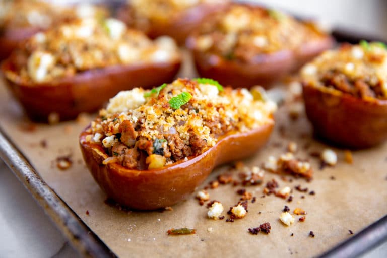 Moroccan lamb stuffed squash on a baking sheet.