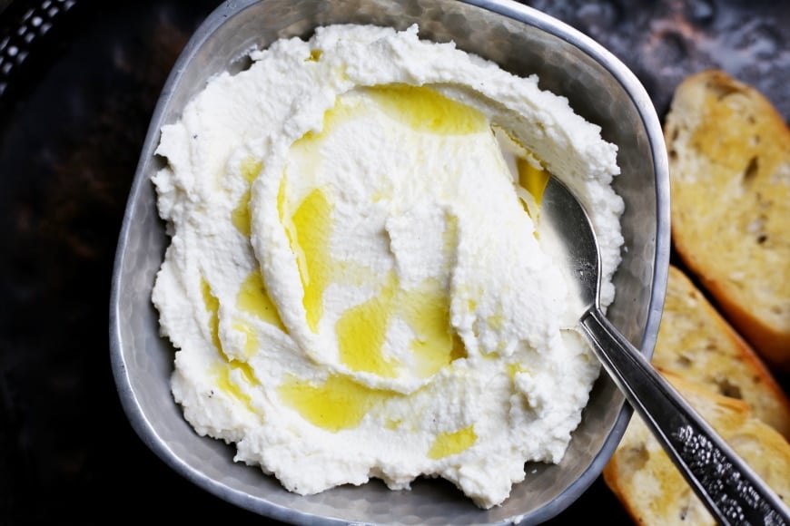 Close up of a bowl of whipped ricotta.