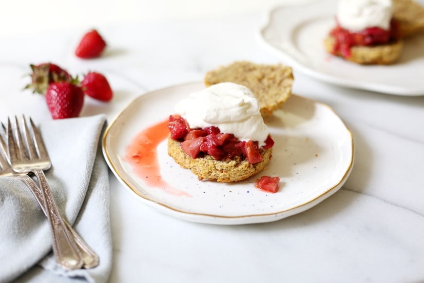 Paleo almond shortcakes on plate with whipped cream and berries