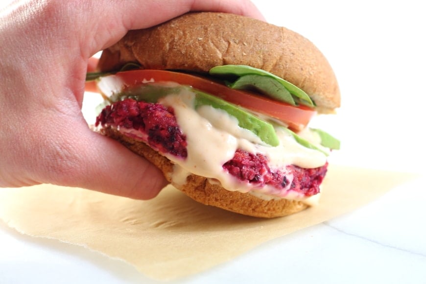 Hand grabbing a gluten free veggie burger