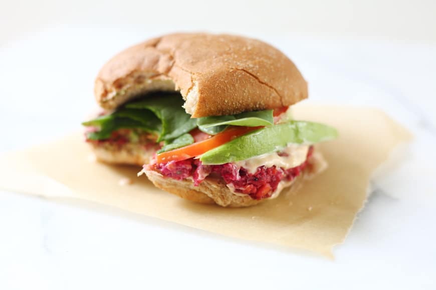 Veggie burger on parchment paper with bite taken out