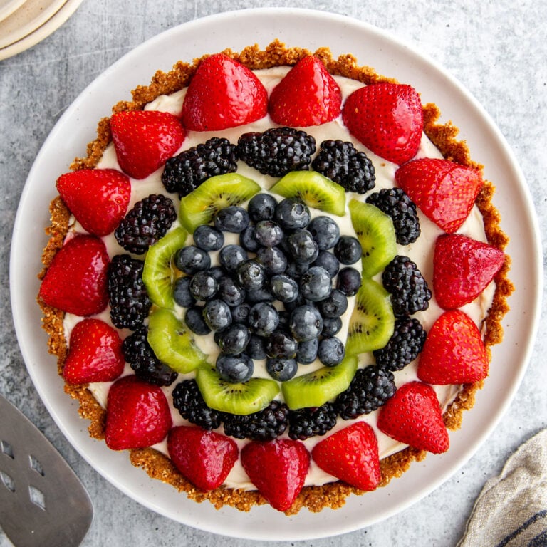 gluten-free tart topped with fresh berries and kiwi