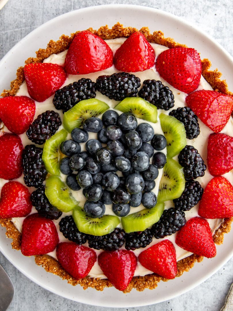 gluten-free tart topped with fresh berries and kiwi