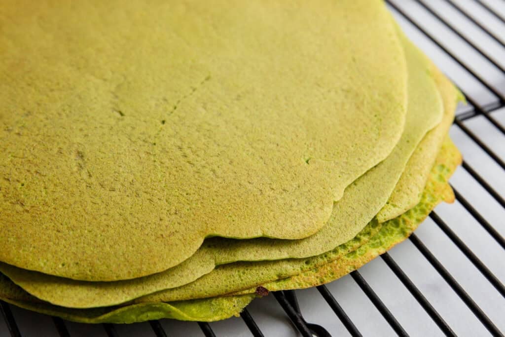 Thin chickpea flatbreads on a cooling rack.