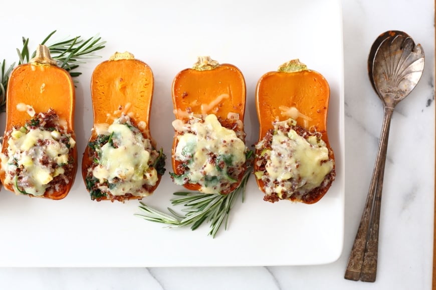 Overhead shot of a platter of stuffed honeynut squashes.