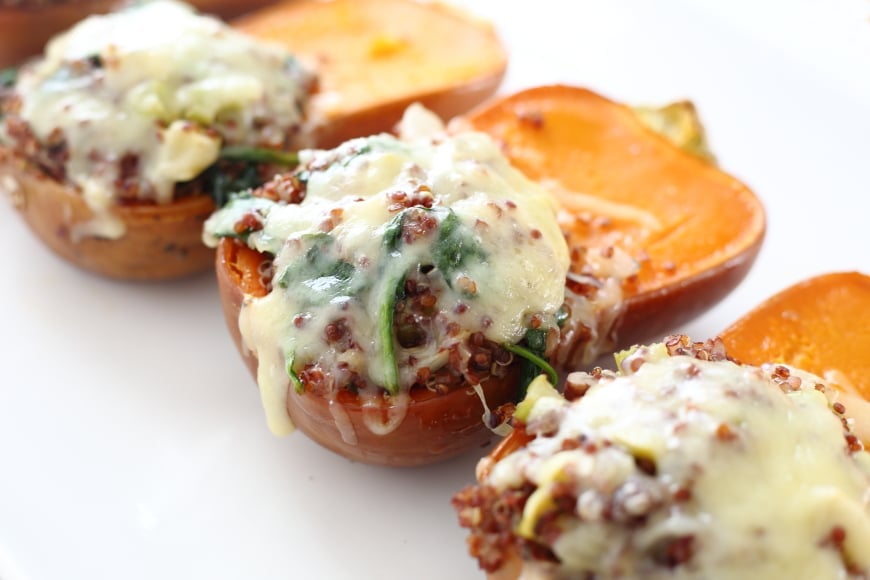 Quinoa and apple stuffed honeynut squash on a serving platter.