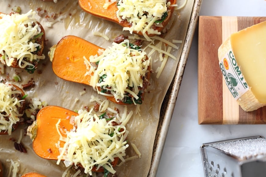 Stuffed honeynut squashes on a baking sheet. 