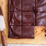 Black bean brownies on a cutting board with a knife.