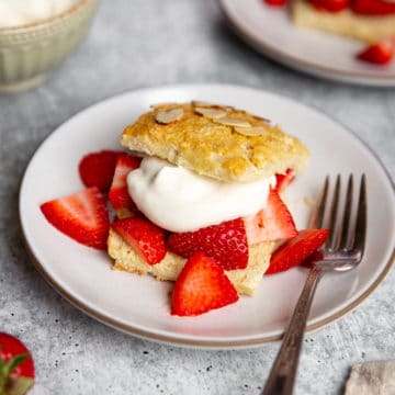Gluten free strawberry shortcake on a plate with a fork.