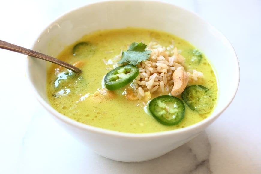 Coconut cashew curry soup in bowl with rice