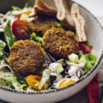 Pan fried falafel in bowl with greens