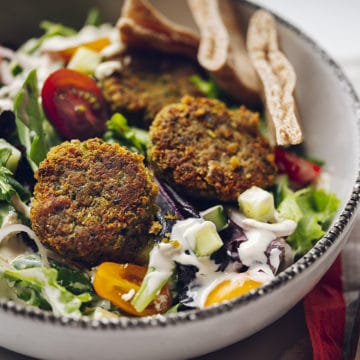 Pan fried falafel in bowl with greens