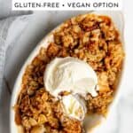 A serving of apple crisp topped with a scoop of vanilla ice cream.