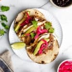 Slow cooker carnitas tacos on a plate.