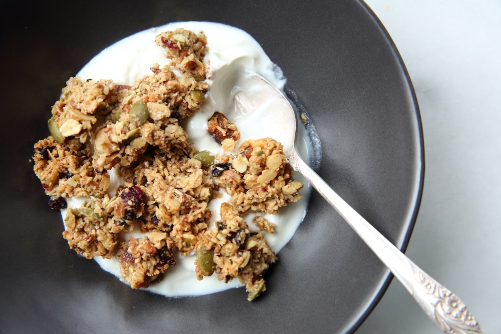 granola clusters recipe, granola clusters in bowl with yogurt