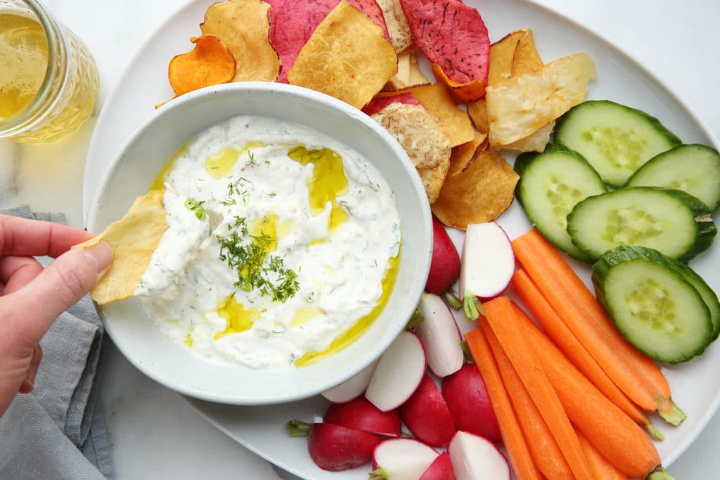 Yogurt feta dip with potato chips and veggies