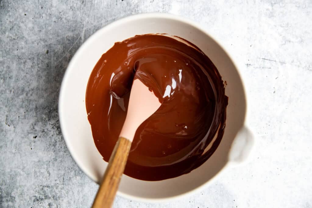 melted chocolate in a bowl with a spatula 