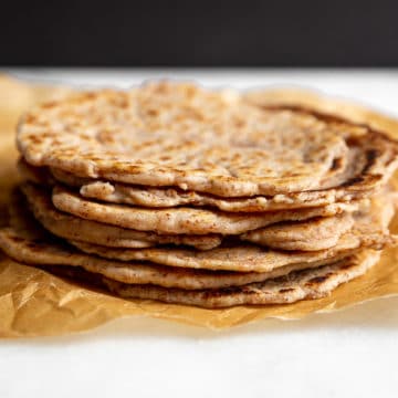 Cassava Tortillas stacked on a piece of parchment paper