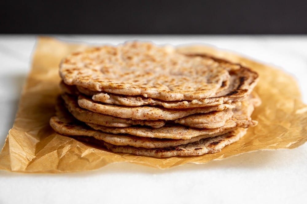 Cassava Tortillas stacked on a piece of parchment paper