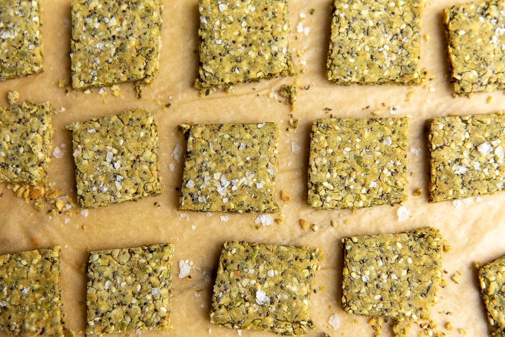 Close-up of seed crackers on parchment paper
