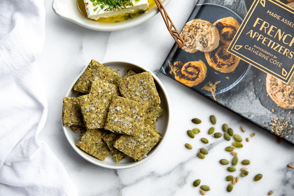 Seed crackers in bowl with French Appetizers book on the side