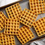 Chickpea waffles spread out to cool on rack over a baking sheet