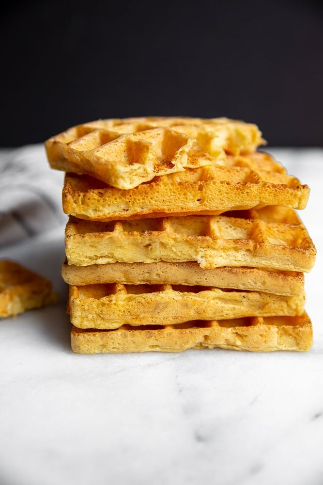 Chickpea waffles stacked in a pile on the counter