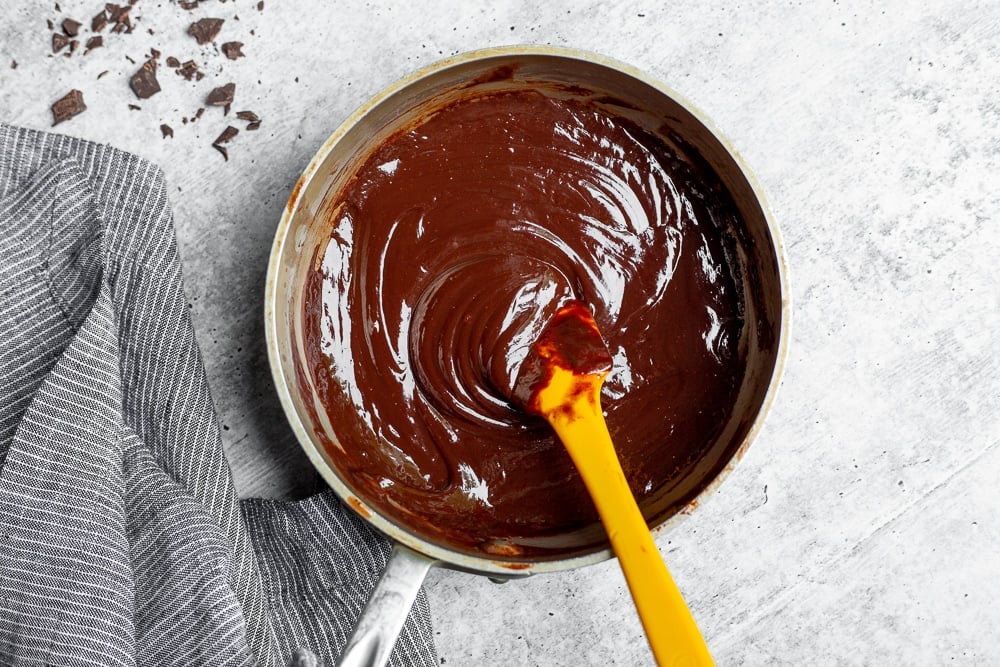 Fudge topping in small saucepan for easy ice cream pie