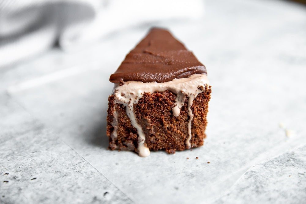 Wedge of easy ice cream pie on counter, with ice cream dripping down from crust