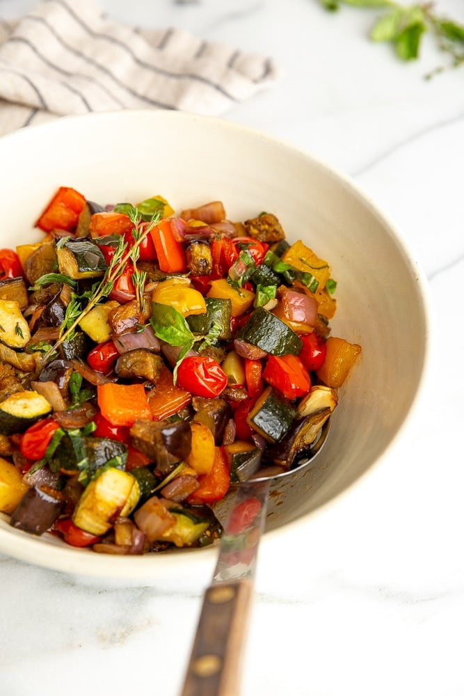 Ratatouille in large serving bowl with serving spoon 