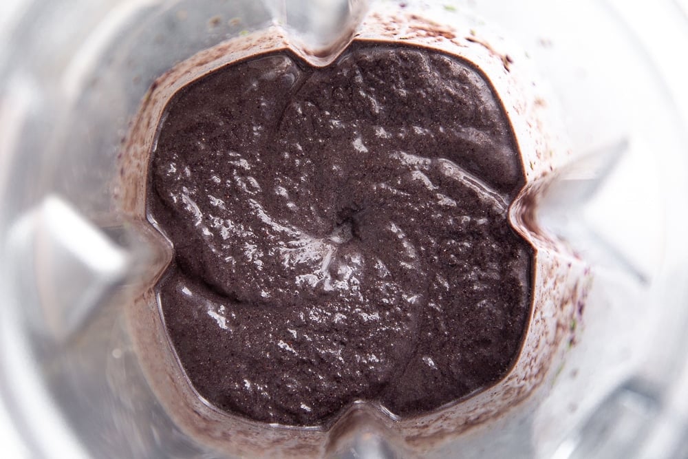 Overhead close-up shot of the smoothie in the blender. 