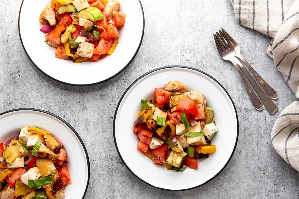 Grilled panzanella salad in serving bowls.